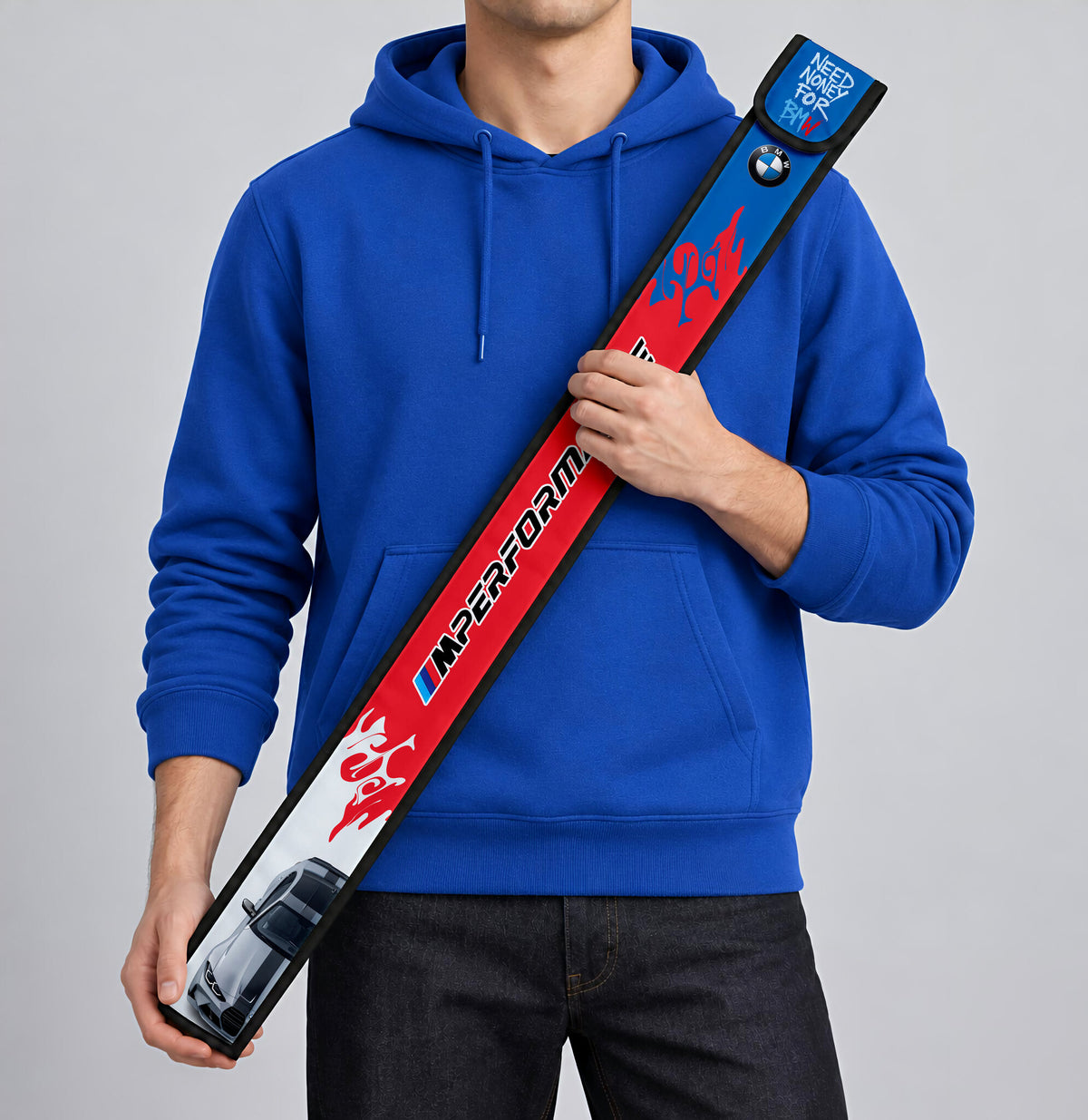 BMW M Colour T-Ruler Cover held against a blue hoodie