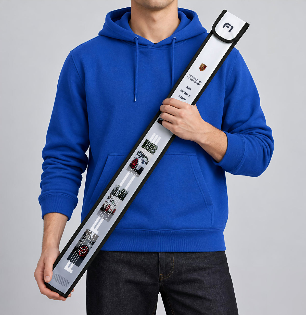 Porsche Motorsport T-Ruler Cover held against a blue hoodie